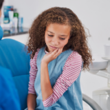 dentist at Lawrence Square Mall treating tooth sensitivity at Dentistry in Motion